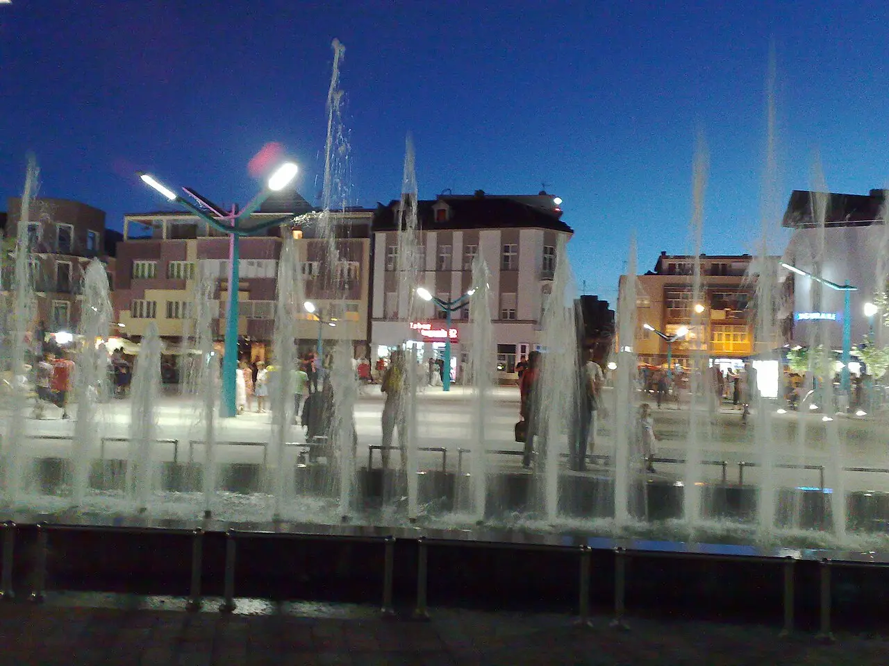 The main square in central Bihać with café terraces and low modern buildings