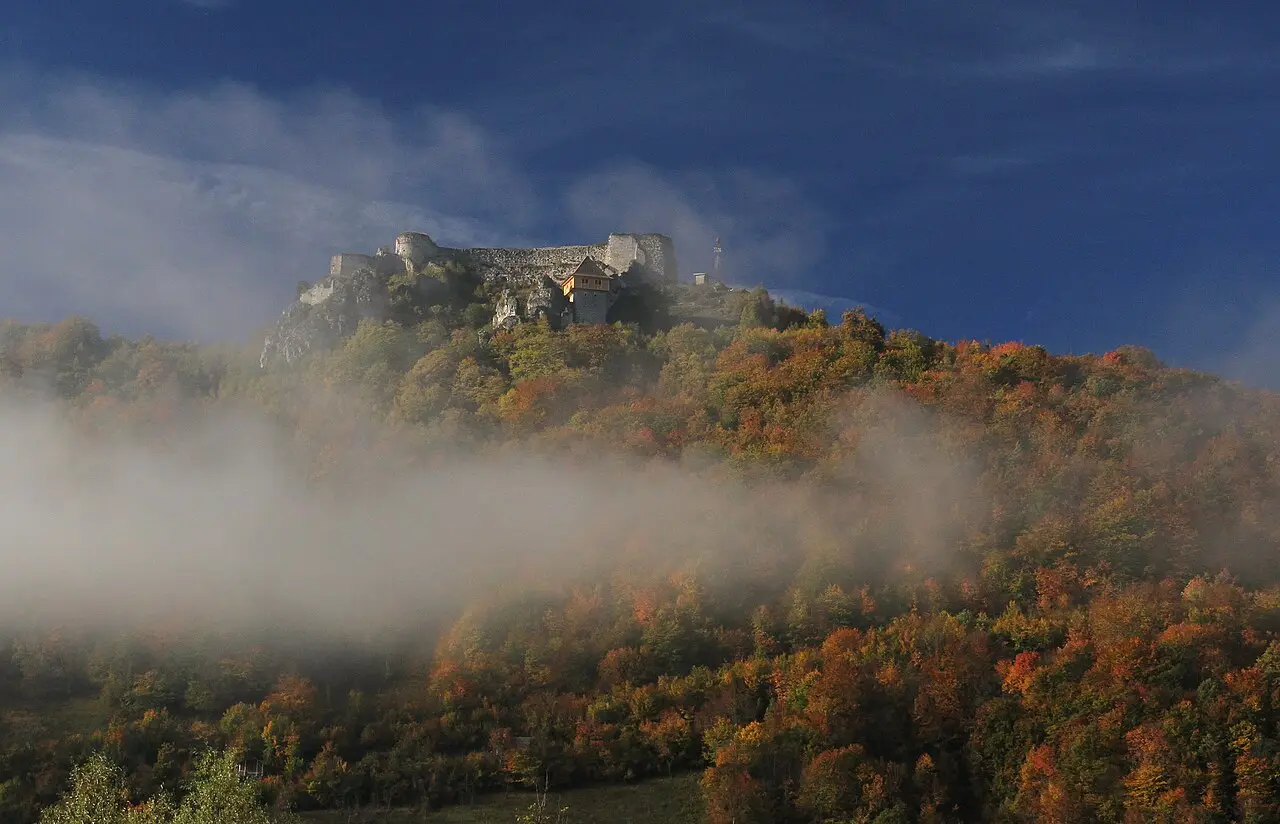 The stone walls of Ostrovica fortress on a wooded hill above Kulen Vakuf