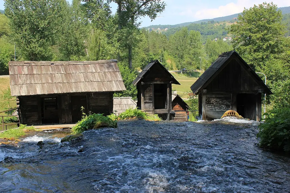 A row of historic wooden watermills on the Pliva river channels west of Jajce town