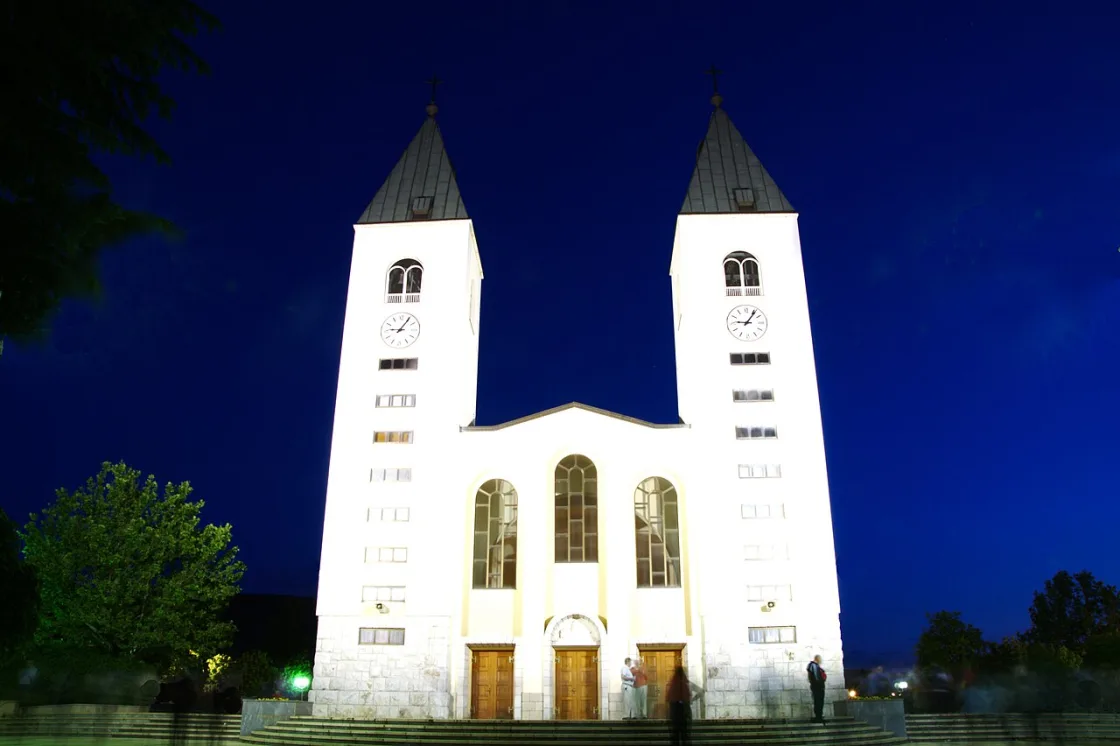 St James Church twin bell towers rising above the wide paved plaza in Medjugorje