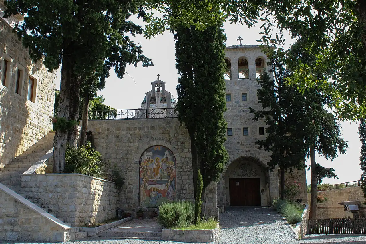 Stone buildings of Tvrdoš Monastery among trees outside Trebinje
