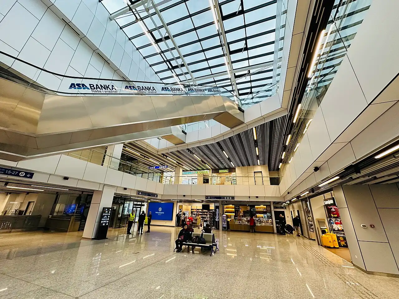 The modern glass departures hall of Sarajevo International Airport lit at night, the main gateway to Bosnia and Herzegovina
